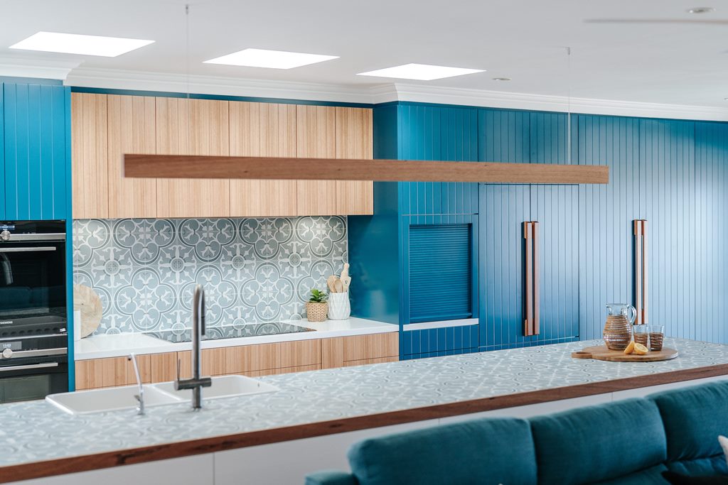 Contessa Dowel 43 Linear Pendant Light suspended ovear a kitchen island bench